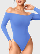 Dacrly Off Shoulder Bodysuit in blue, front view pose with hand at neck, off shoulder neckline highlighting collarbone, fitted design