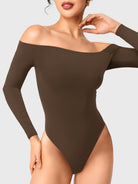 Dacrly Off Shoulder Bodysuit in deep brown, front view with hand at neck, off shoulder neckline highlighting collarbone and neck