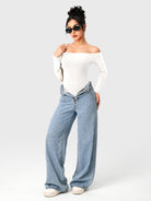 Dacrly Off Shoulder Bodysuit in white, full body front view layered with jeans, styled with sunglasses and shoulder bag, Y2K outfit